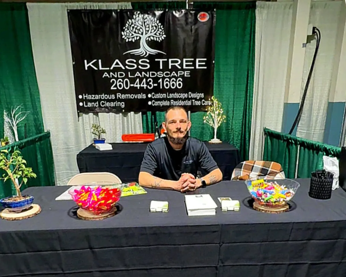 Owner of Klass Tree and Landscape seated at the Fort Wayne Home and Garden Show booth